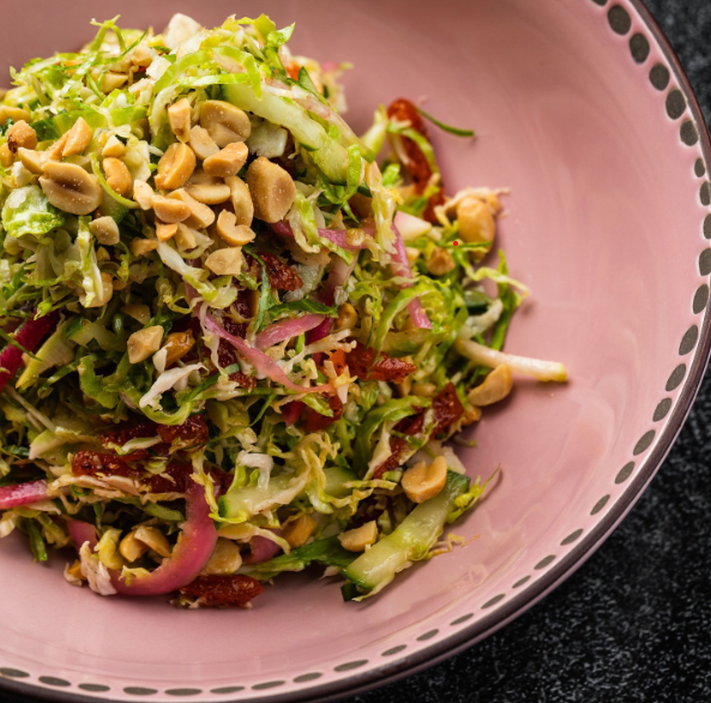 Best shaved Brussels sprouts salad in Las Vegas at La Neta — a vibrant mix of chili mango, peanuts, and white balsamic vinaigrette.