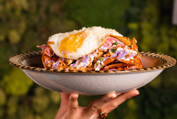 Trash-Quiles chilaquiles with chicken tinga, fried egg, crema, and pickled onions served at La Neta in Las Vegas