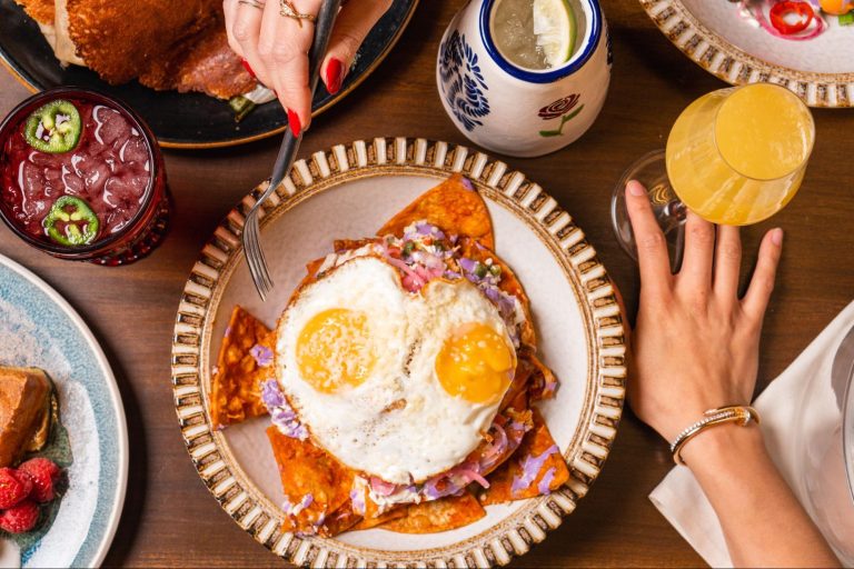 Trash-Quiles chilaquiles with eggs, chicken tinga, rojo sauce, crema, and pickled onions served at La Neta in Las Vegas